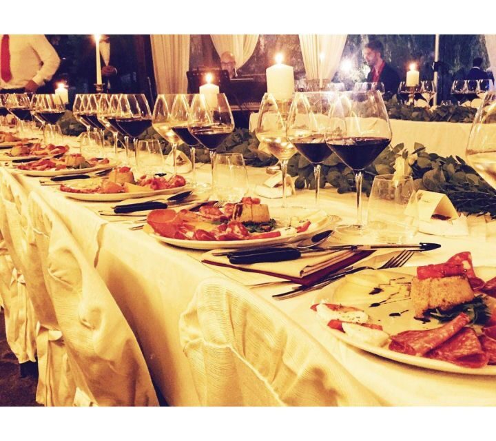 From Florence: Outdoor Wine Dining in San Gimignano Winery - The winery welcome walk and seasonal dinner setup (summer outdoors, winter fireplace)